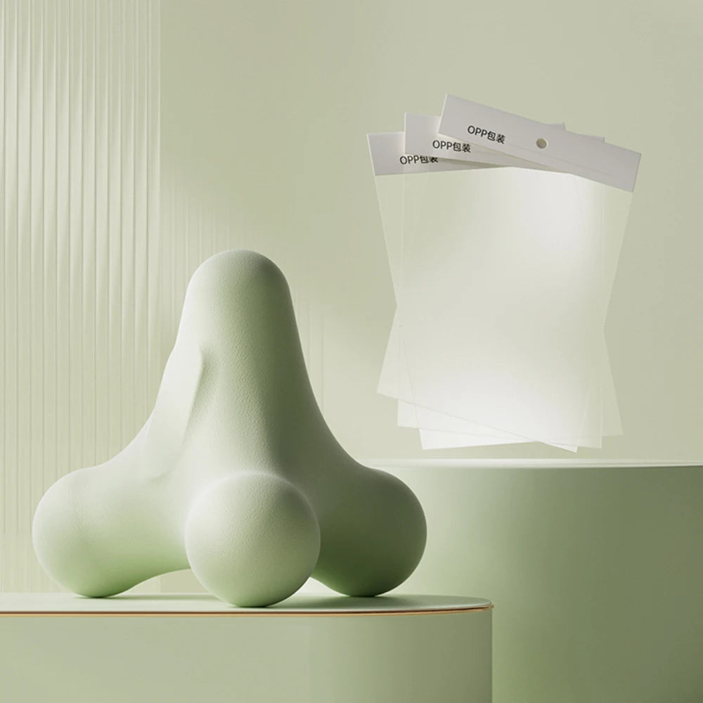 Soft green ergonomic massage tool with three OPPE-labeled plastic sheets in clean, vertical-lined background