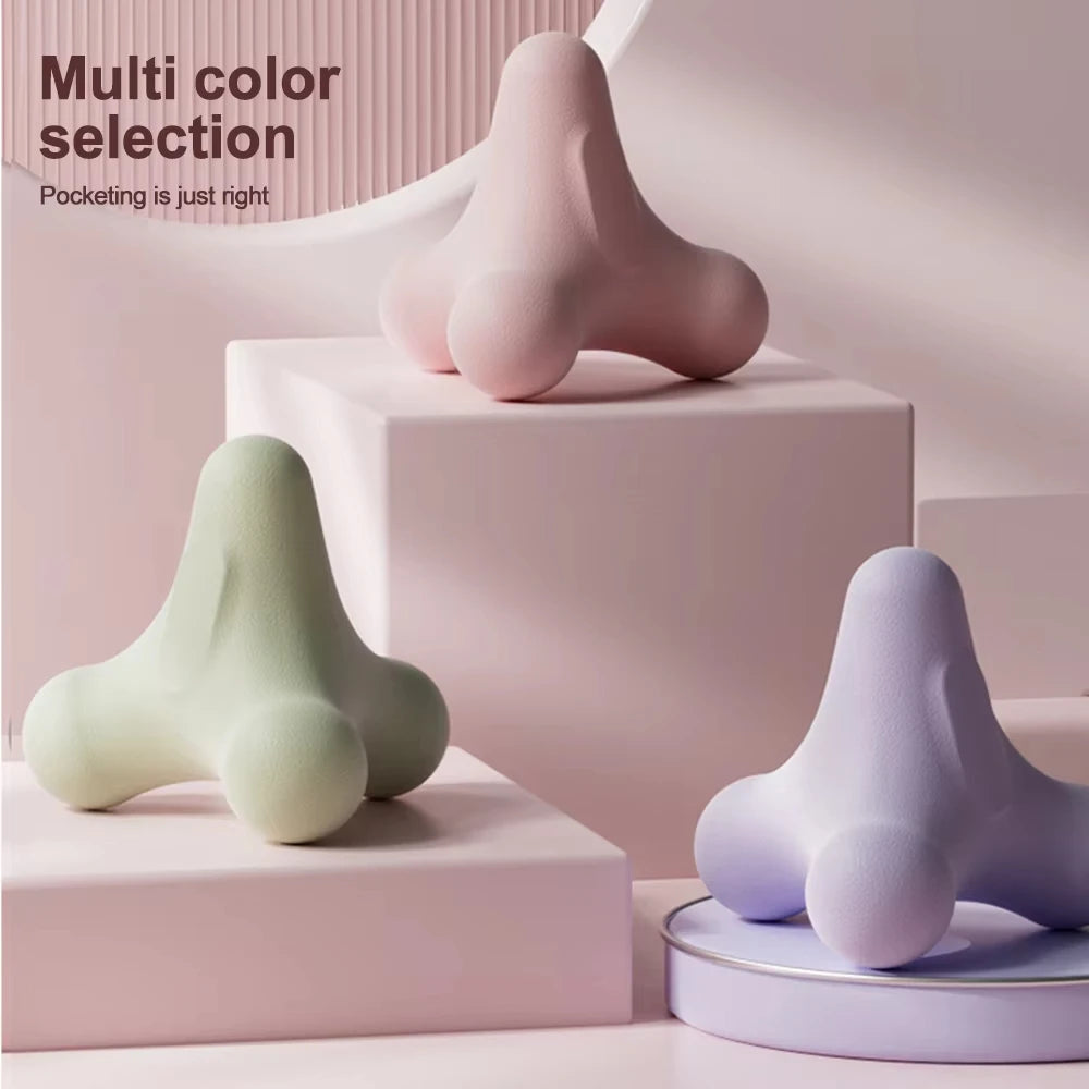 Pastel pink, green, and lavender ergonomic massage tools displayed on minimalist platforms for color selection
