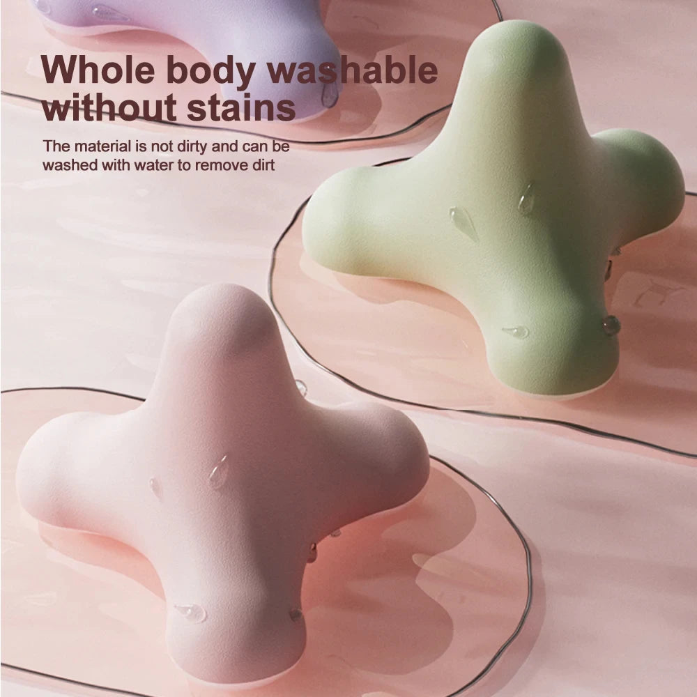 Pastel pink and green washable massage tools on wet surface highlighting stain-resistant and waterproof design